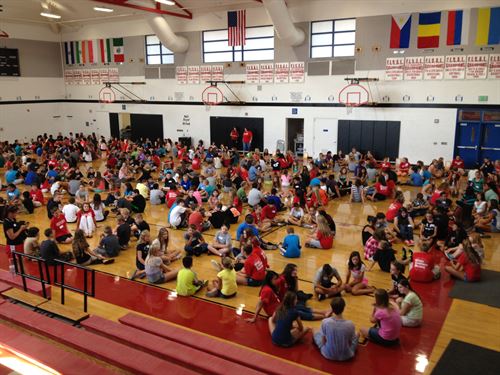 students seated on gymnasium floor viewed from above